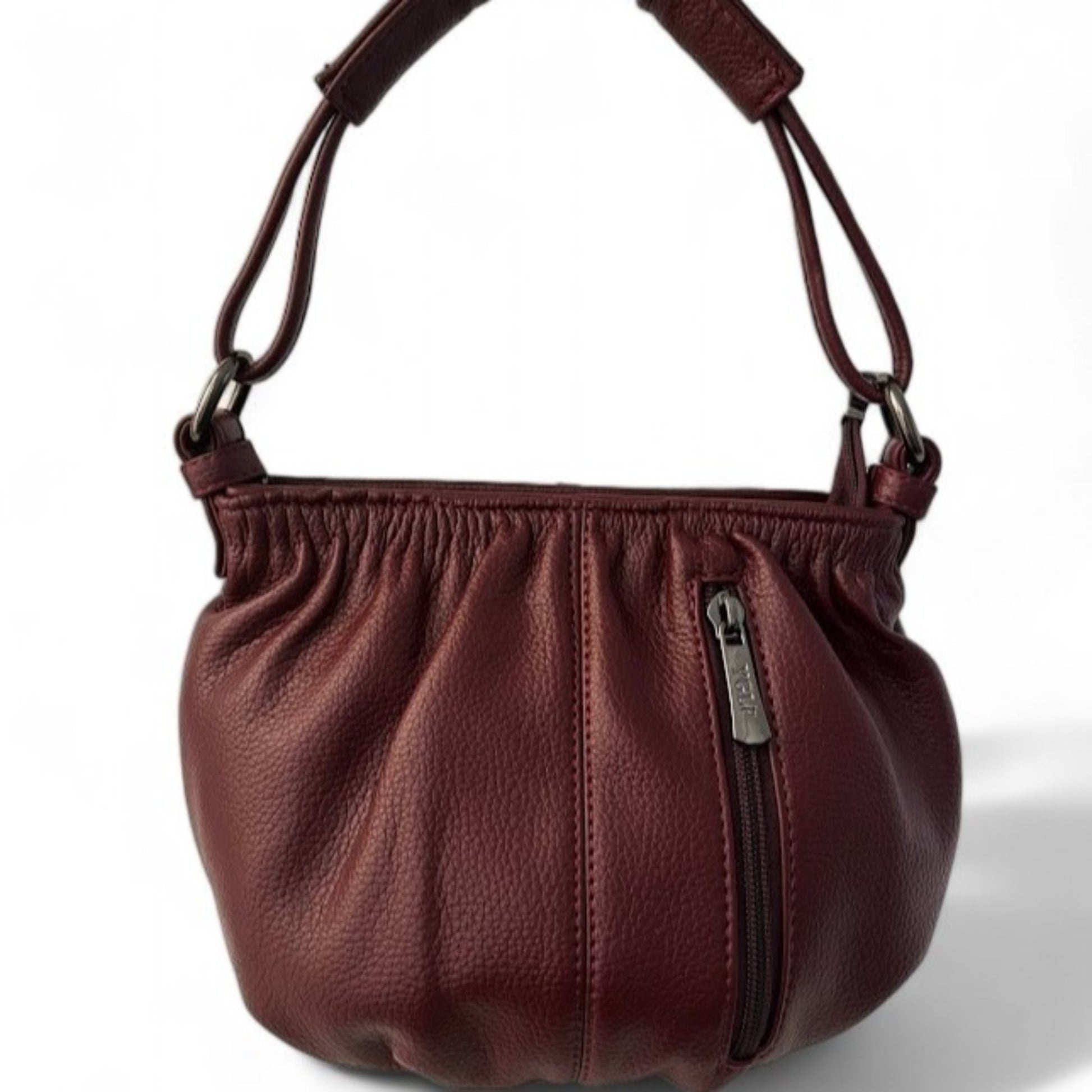 Close-up view of a maroon pleated bucket bag featuring a vertical front zip pocket and a top handle.