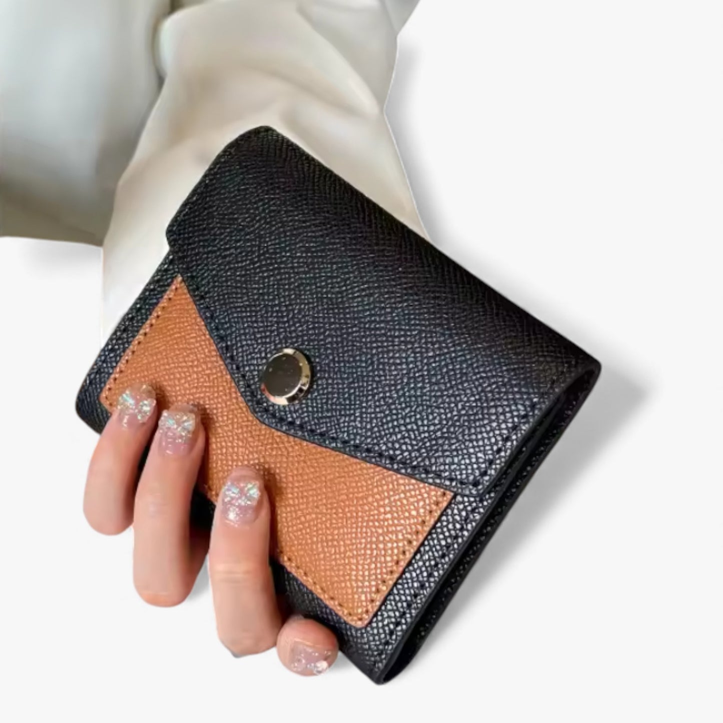 Small trifold black-and-brown Epsom-textured vegan PU leather wallet with a gold snap button.