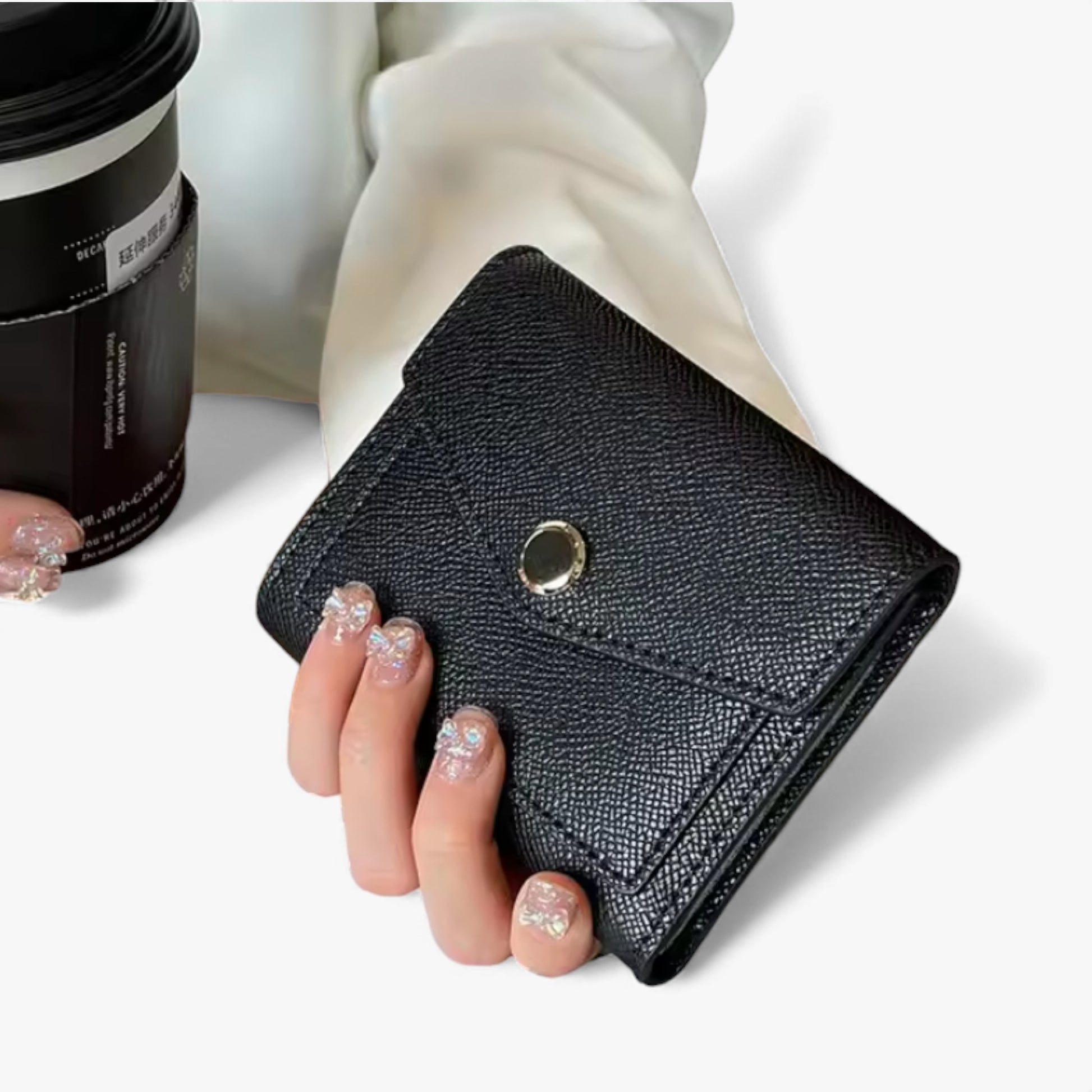 Small black Epsom-textured PU vegan leather wallet with a gold front snap button.