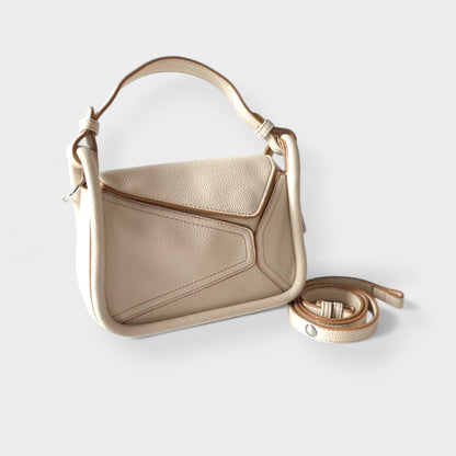 White geometric handbag featuring contrast stitching, top handle, and detachable long strap.