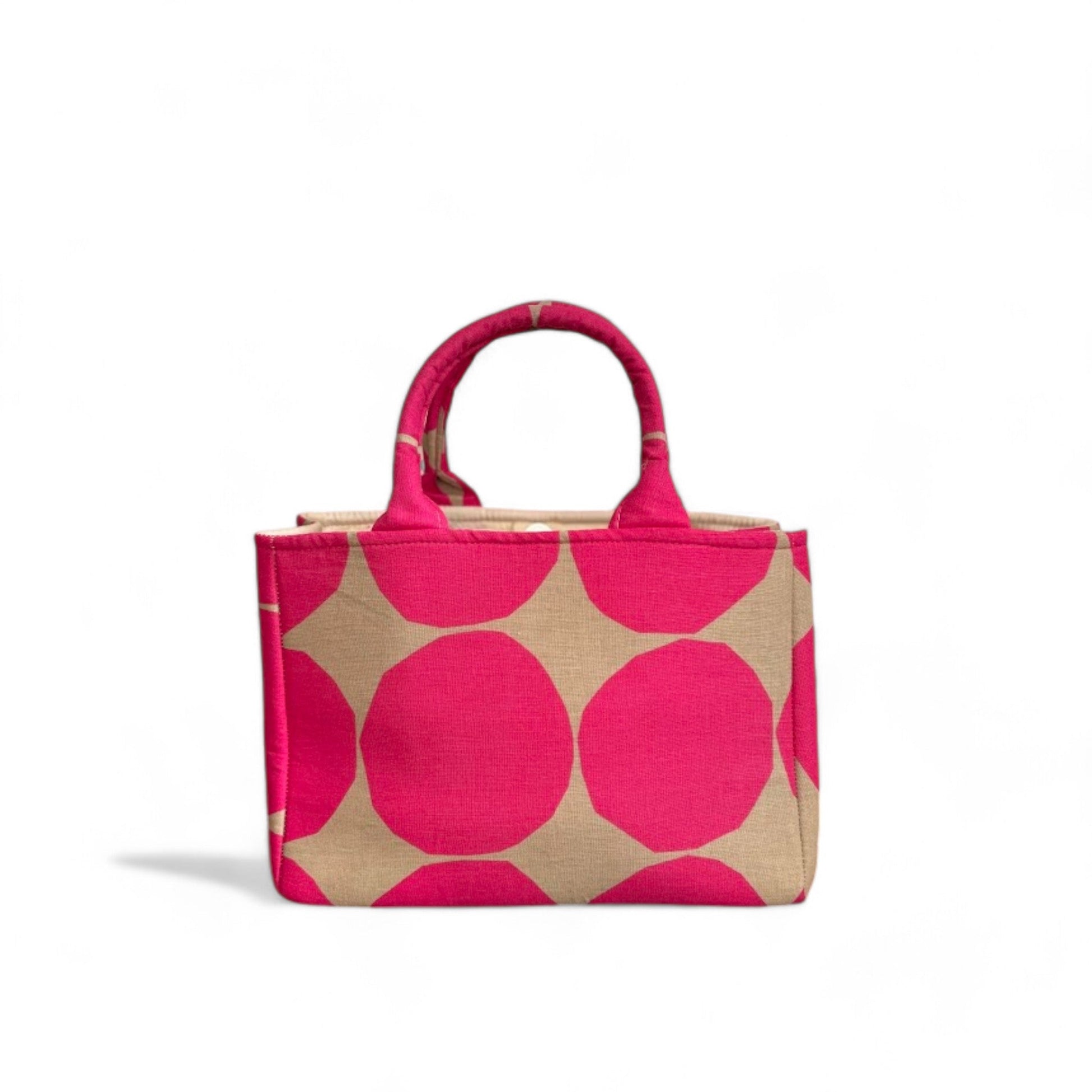 A handmade fabric mini tote with a hot pink and tan dot pattern.
