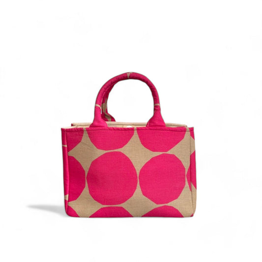 A handmade fabric mini tote with a hot pink and tan dot pattern.
