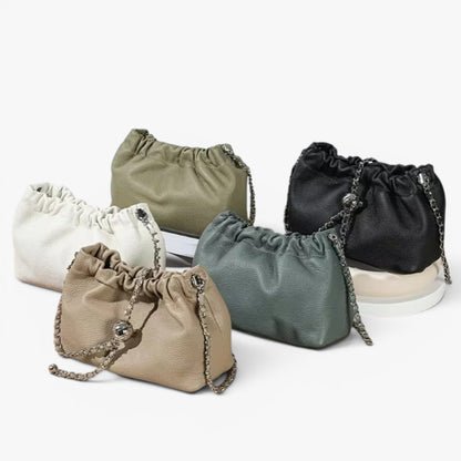 Set of five drawstring ruched leather bags in various colours.