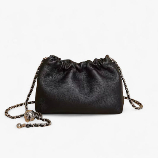 Black leather handbag with top ruched detail and a silver chain strap.