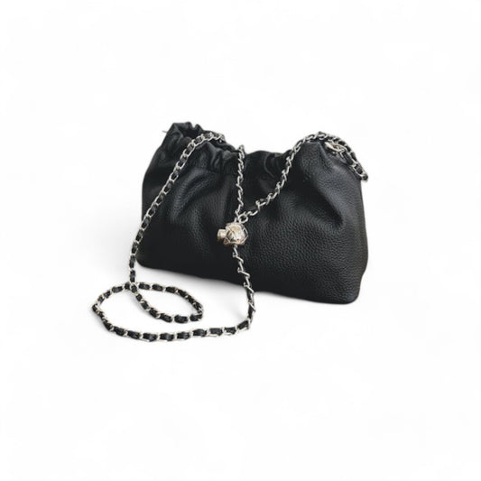 Black leather handbag with top ruched detail and a silver chain strap.