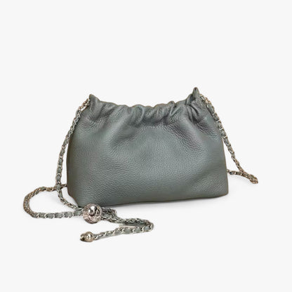 A dark grey blue leather handbag with a ruched top and a silver chain strap.