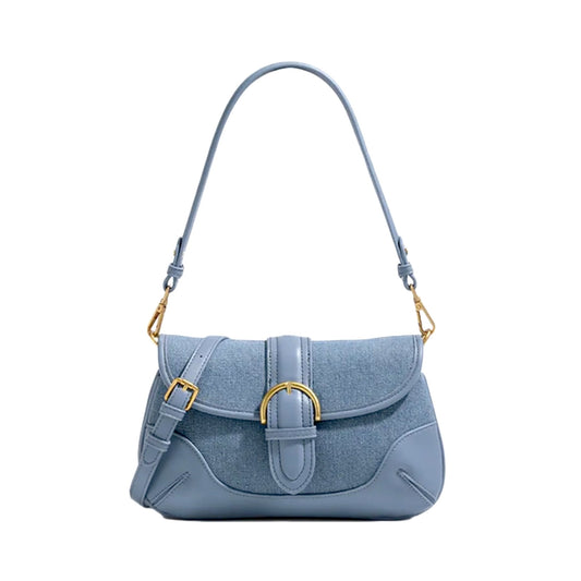 Blue denim shoulder bag with vegan leather trim, featuring a brass-tone buckle on a structured flap and 2 detachable straps.