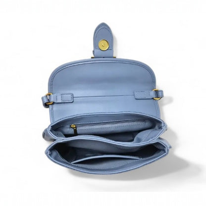 Interior view of a blue denim, fully lined bag with two compartments—one with a zip pocket, and the other with a slip pocket.