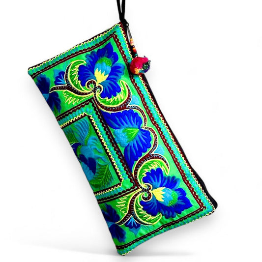 A rectangular clutch bag with peacock and floral patterns in vibrant green and blue.