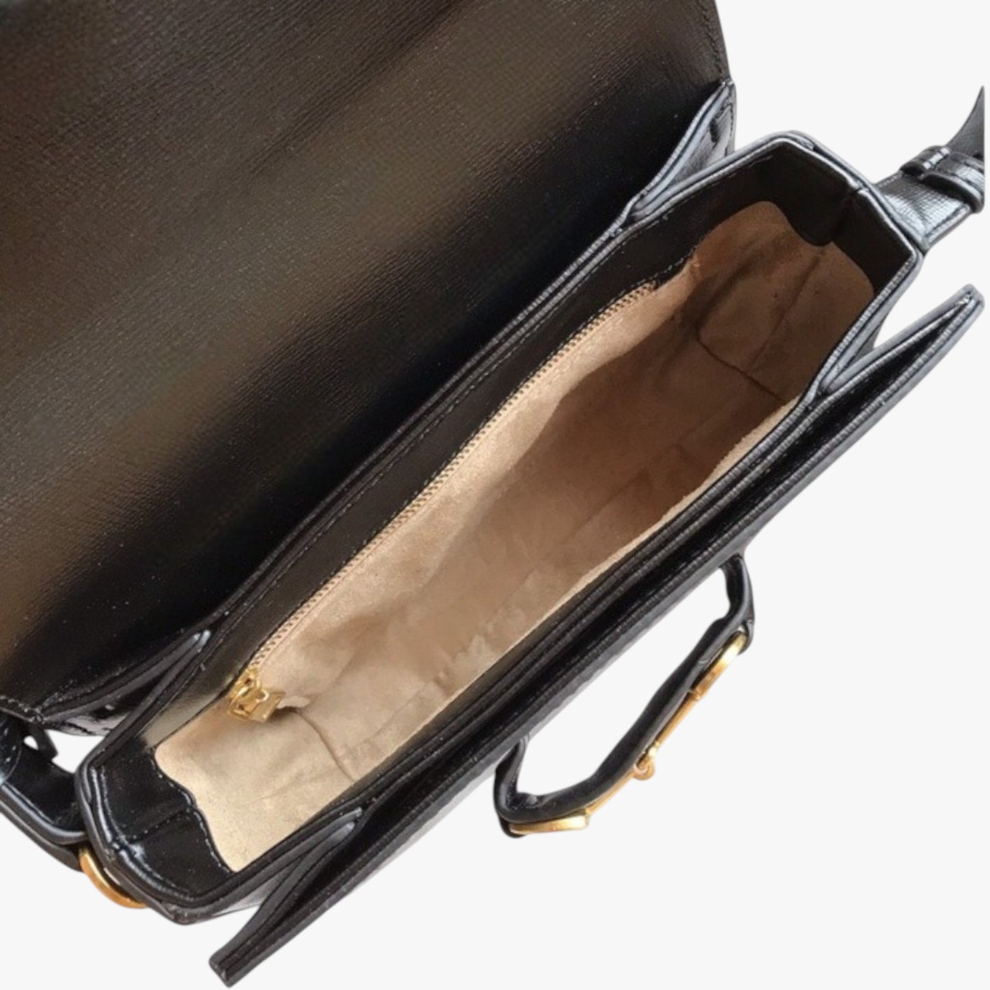Top view of a classic structured handbag showing an interior with light-coloured lining and zip pocket.