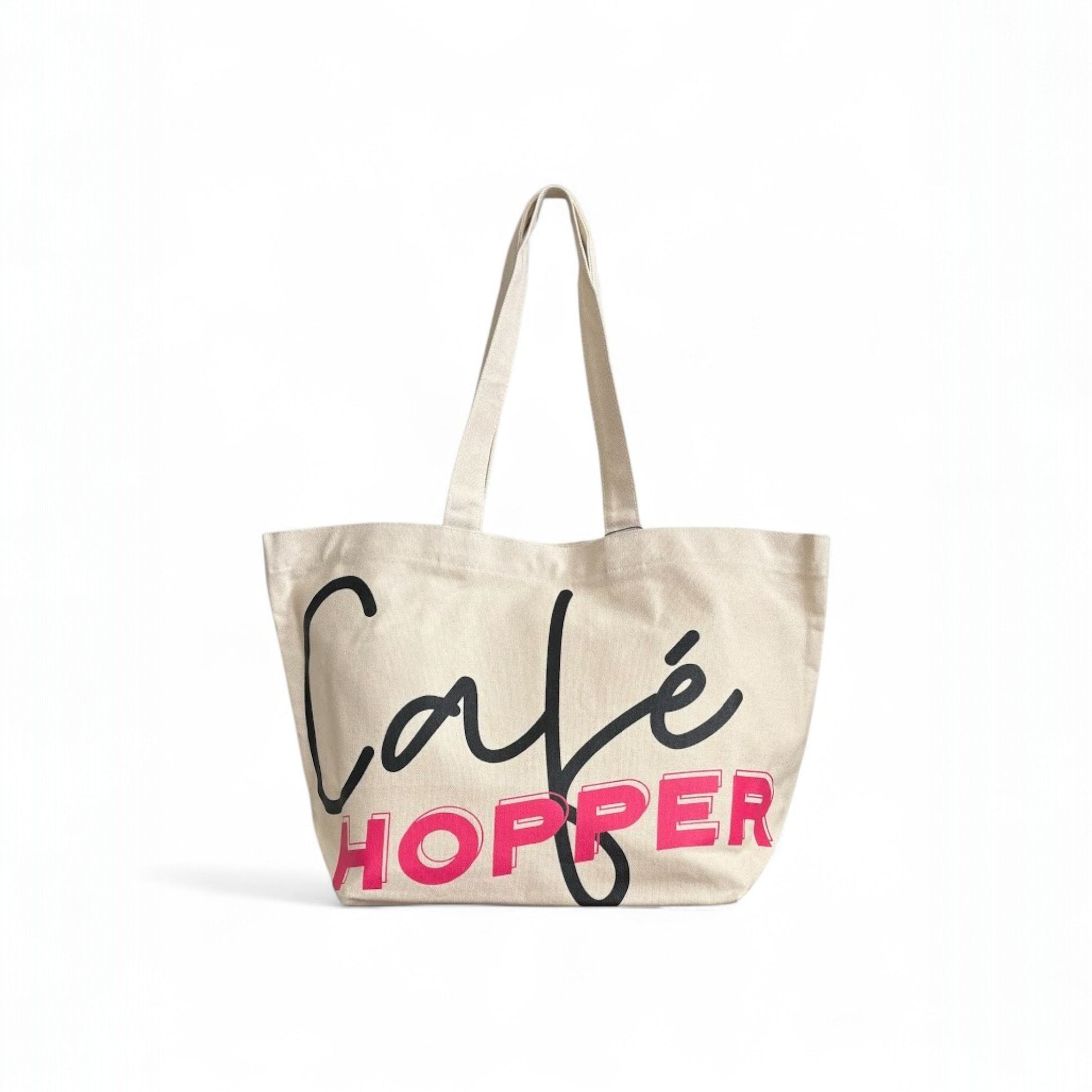 Large Café Hopper canvas tote bag with bold black and pink print, and long straps.