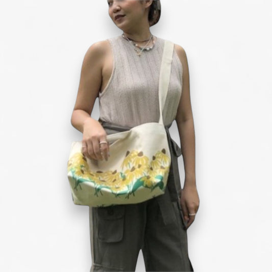 Woman wearing a durable sunflower canvas tote crossbody.